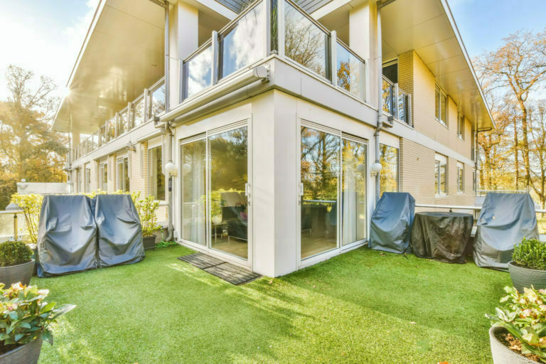 Comfortable balcony with artificial grass